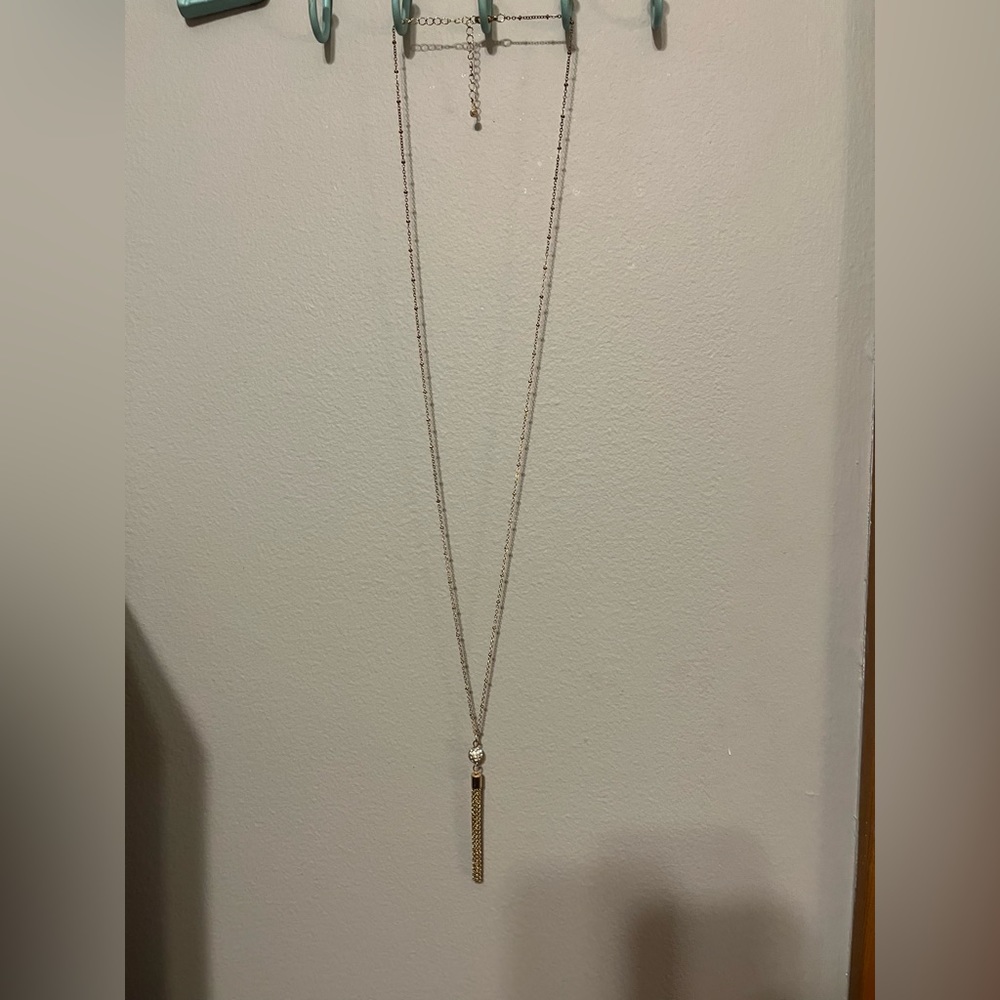 Long gold necklace with diamond ball